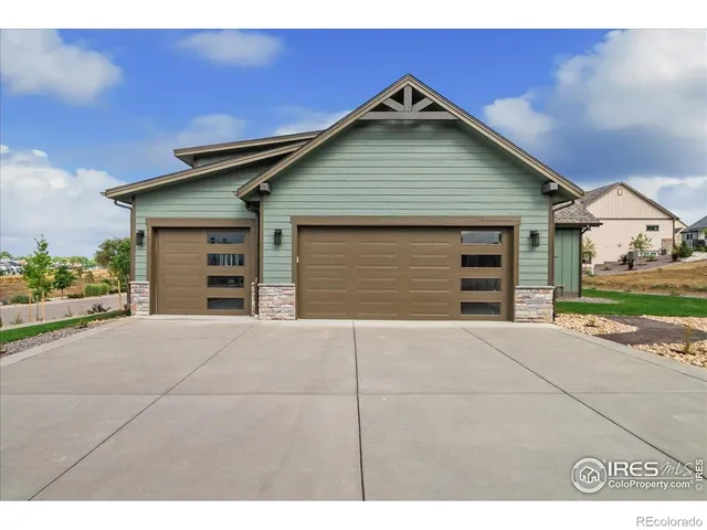 a view of a room with a ceiling fan and wooden floor