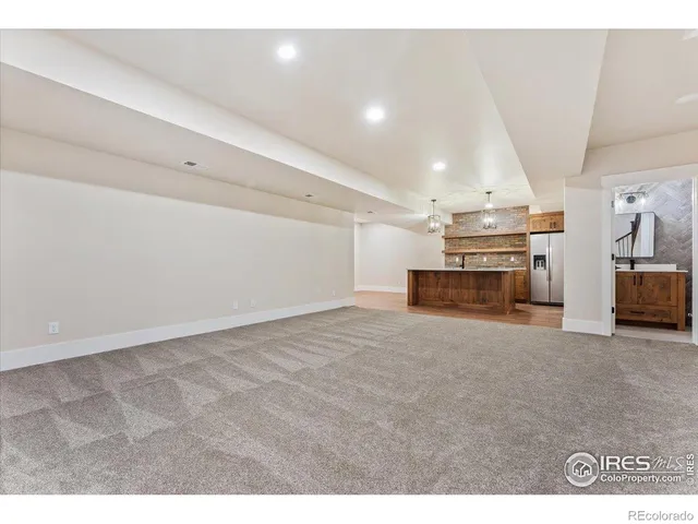 a front view of a house with a garden and yard