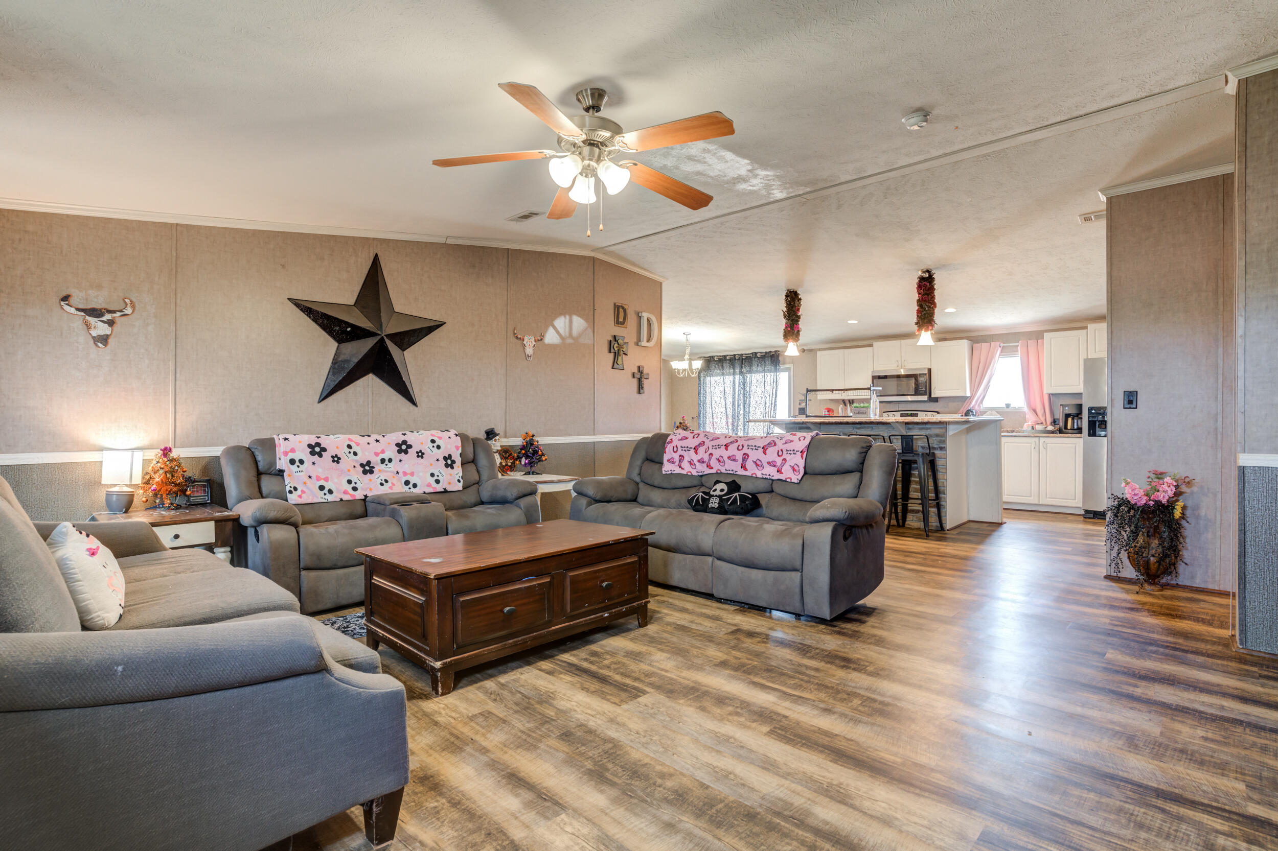 4726 County Road 5300 Lubbock, TX 79415 - Photo 12 of 53 a living room with furniture kitchen view and a chandelier