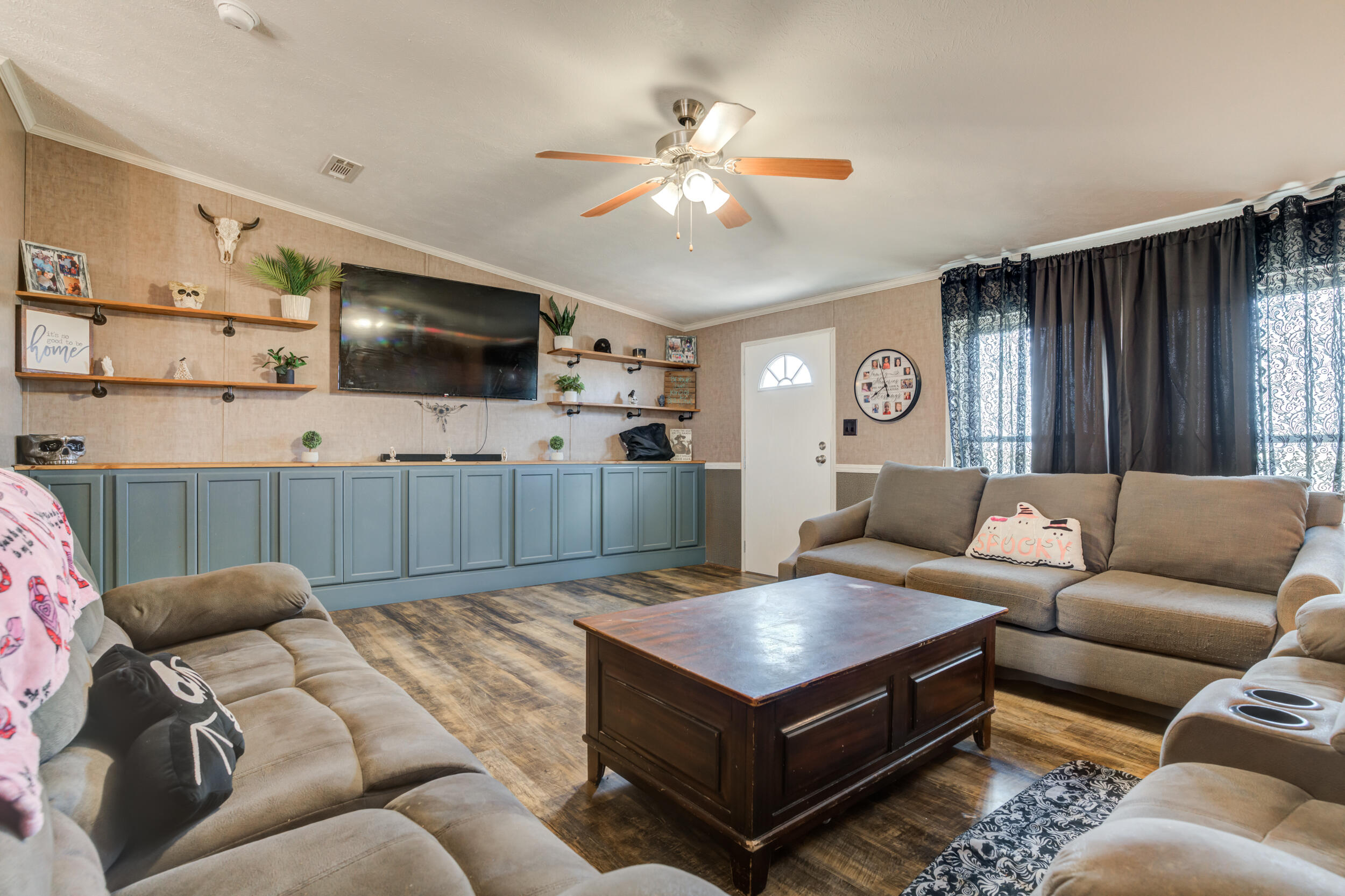 4726 County Road 5300 Lubbock, TX 79415 - Photo 13 of 53 a living room with furniture and a flat screen tv