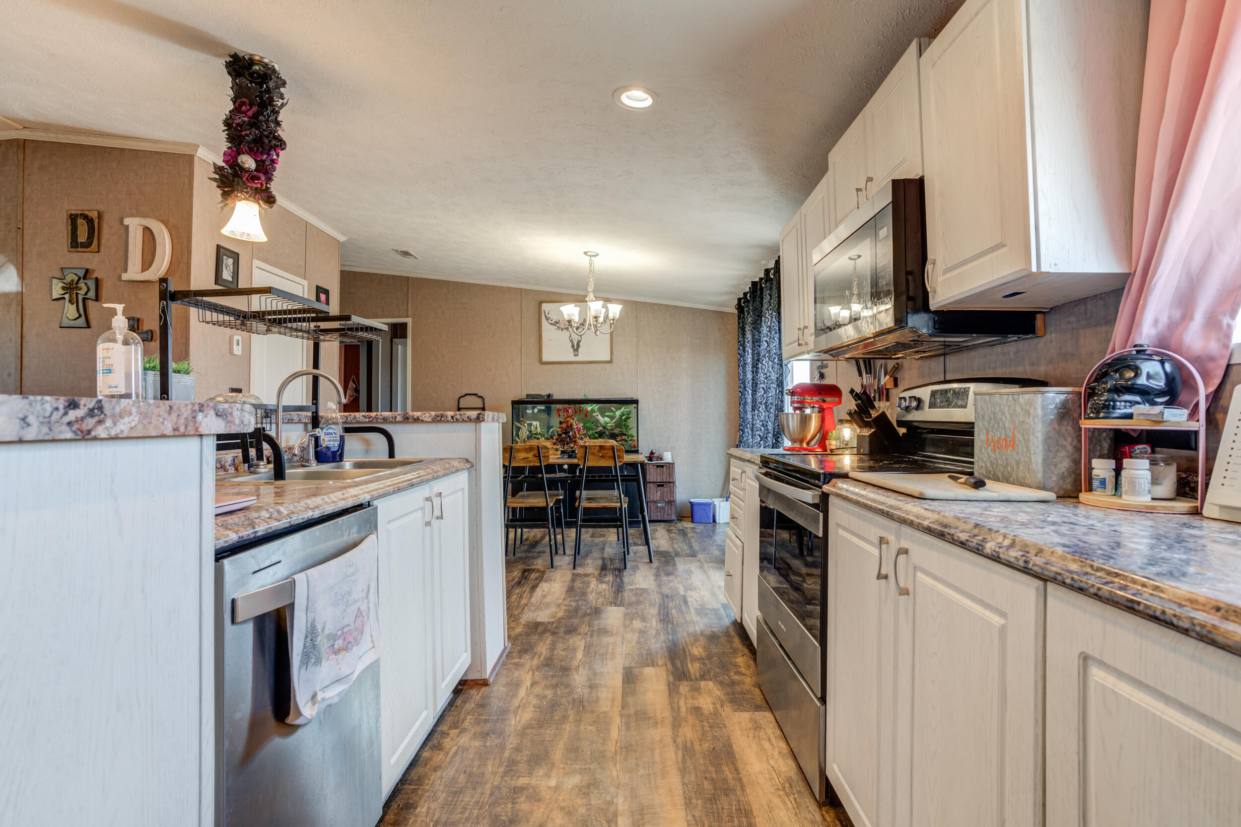 4726 County Road 5300 Lubbock, TX 79415 - Photo 20 of 53 a kitchen with kitchen island granite countertop lots of counter top space and a sink