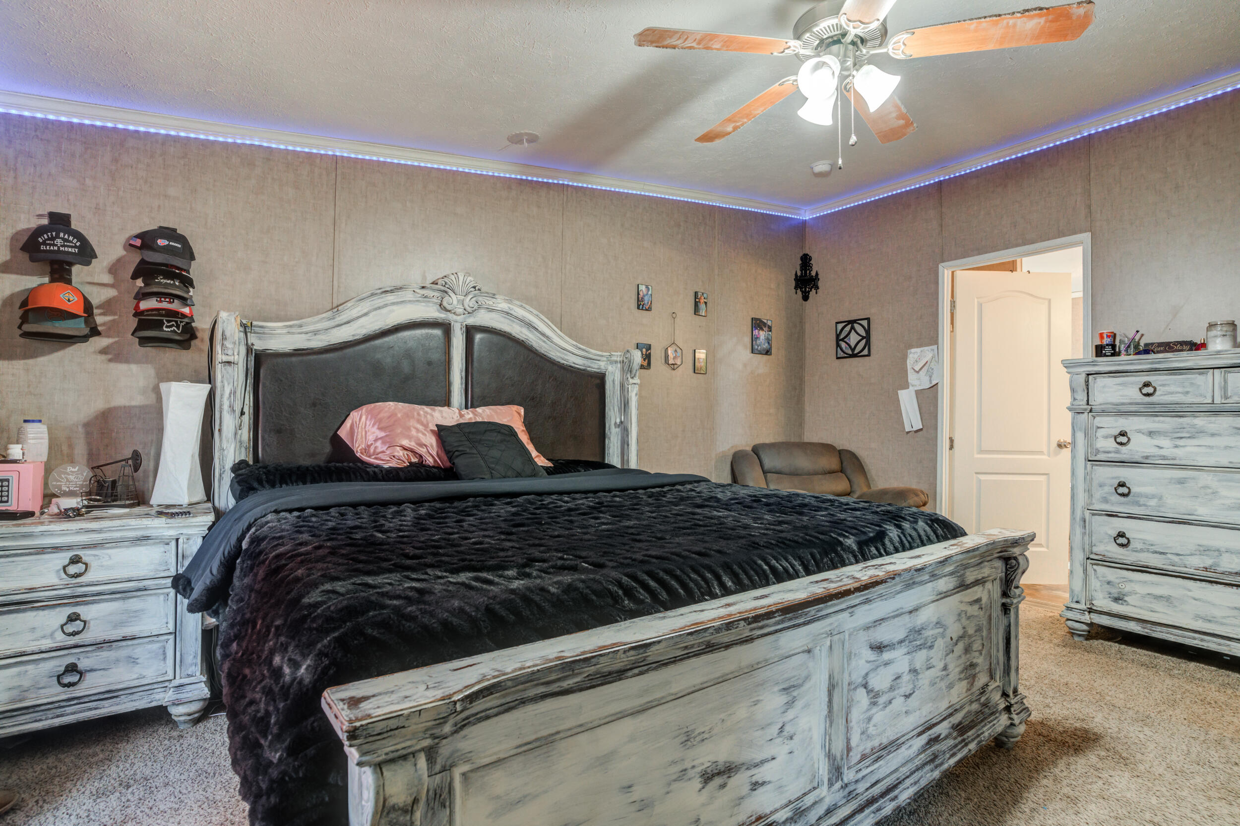 4726 County Road 5300 Lubbock, TX 79415 - Photo 31 of 53 a bedroom with a bed and a chandelier