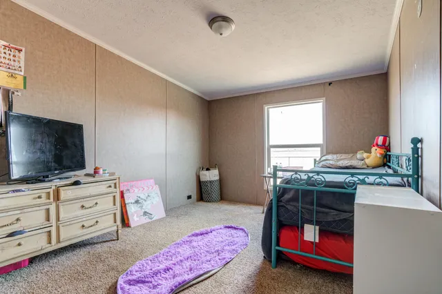 a bathroom with a granite countertop sink a toilet and a shower