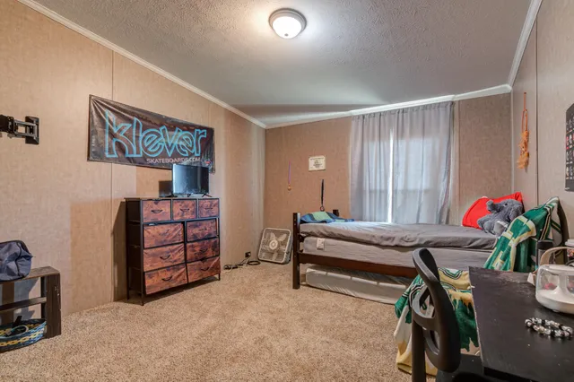 a view of walk in closet with clothes