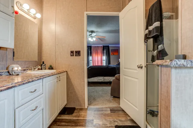 a backyard of a house with glass top table and chairs