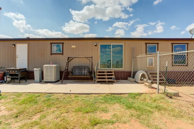 a front view of a house with a yard and ocean view