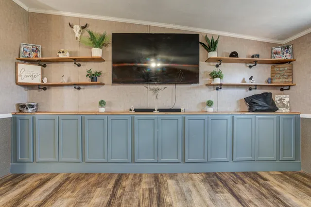 a living room with furniture and a ceiling fan