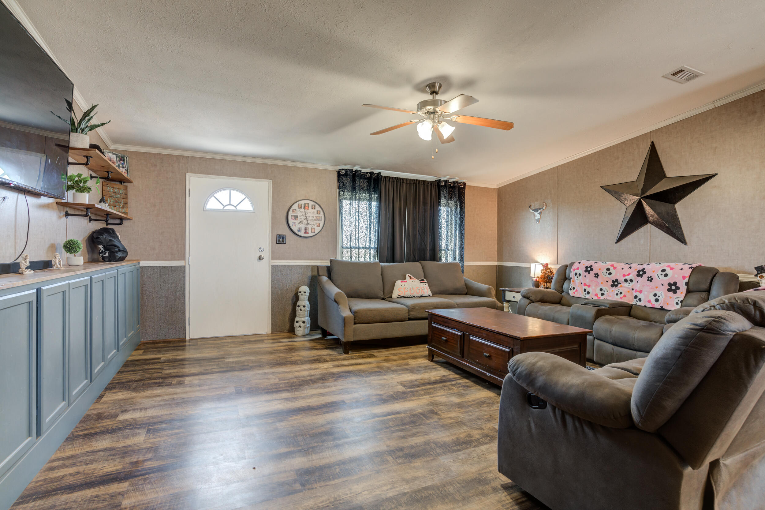 4726 County Road 5300 Lubbock, TX 79415 - Photo 10 of 53 a living room with furniture and a chandelier