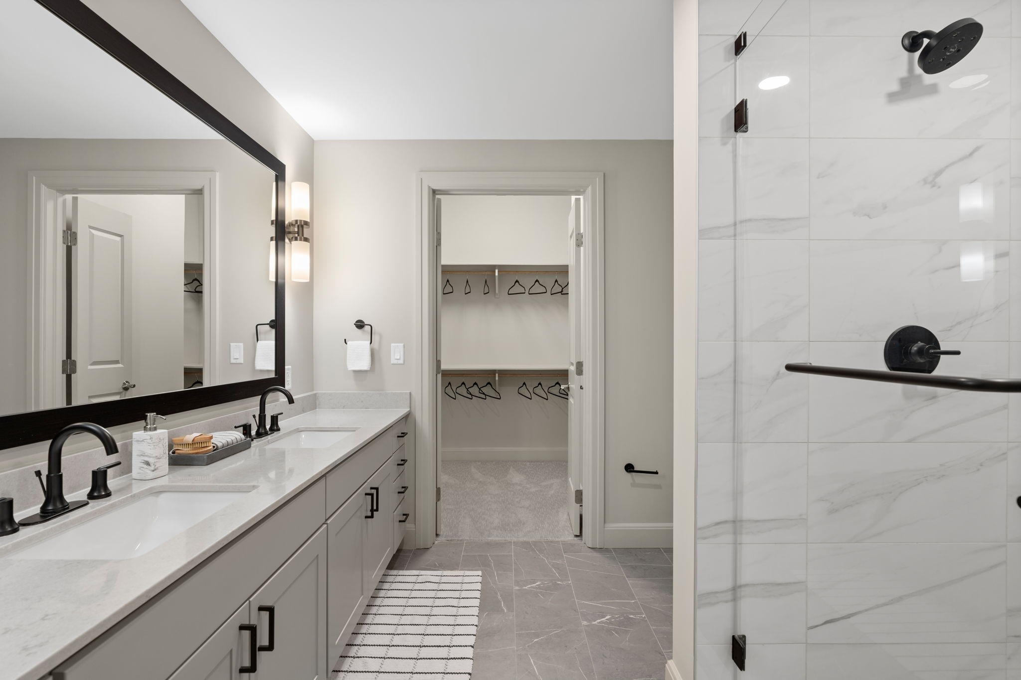 2511 Willowick Road, Unit 317 Houston, TX 77027 - Photo 15 of 44 a bathroom with a double vanity sink a mirror and a shower