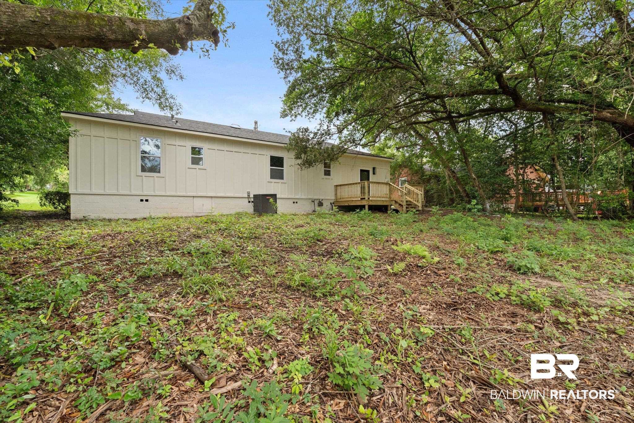 3512 Spring Hill Avenue Mobile, AL 36608 - Photo 19 of 20 Back of property with a wooden deck and crawl space
