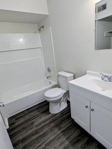a bathroom with a toilet a sink and bathtub