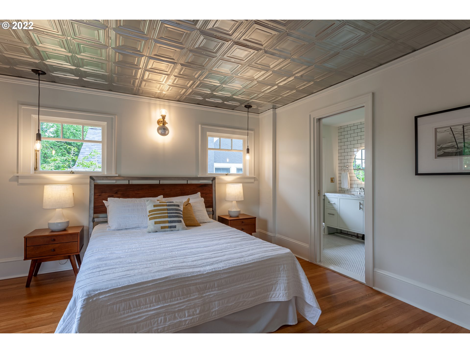 3345 Northeast Holladay Street Portland, OR 97232 - Photo 13 of 32 a bedroom with a large bed and a chandelier