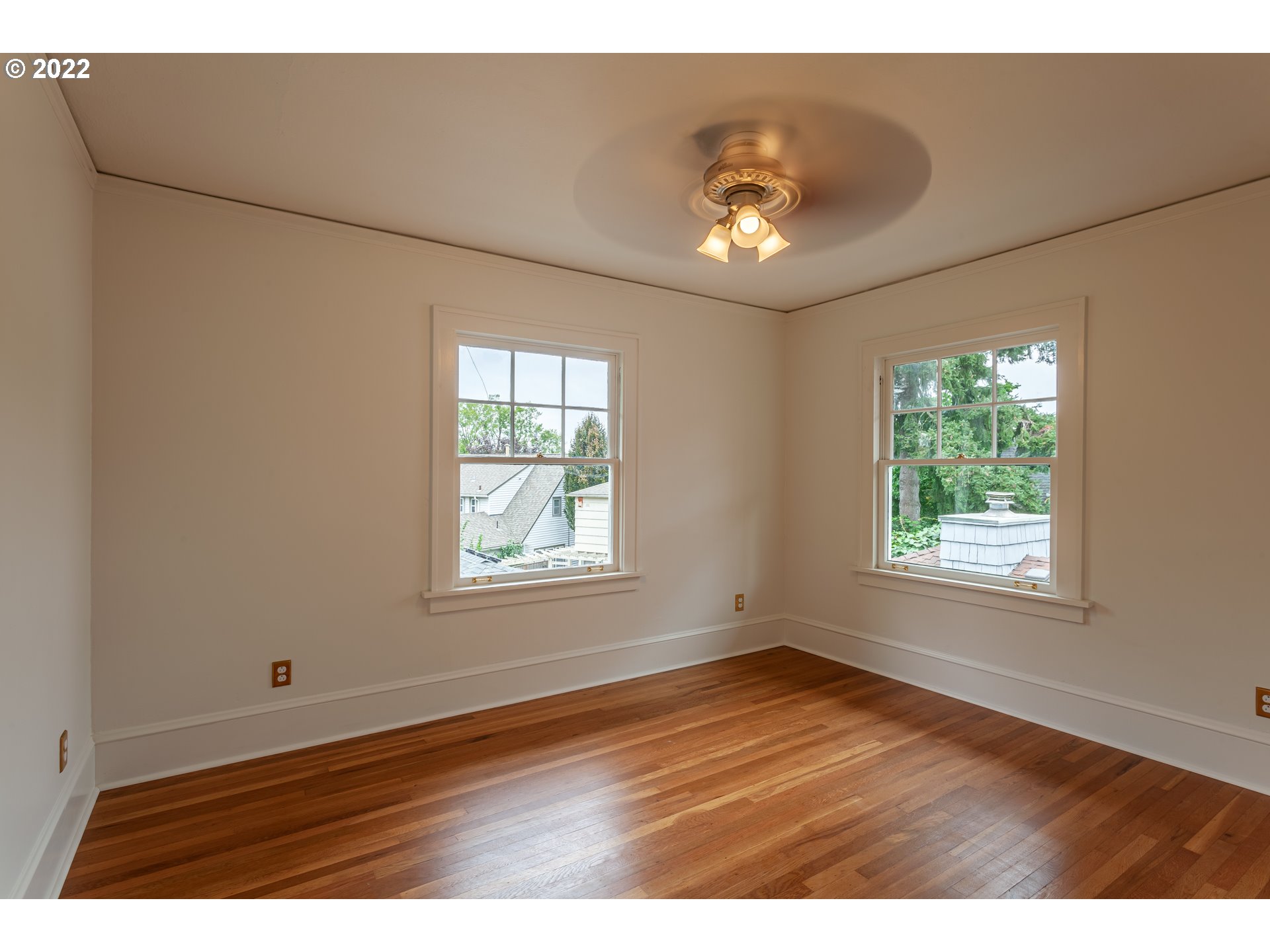 3345 Northeast Holladay Street Portland, OR 97232 - Photo 16 of 32 a view of an empty room with wooden floor and a window