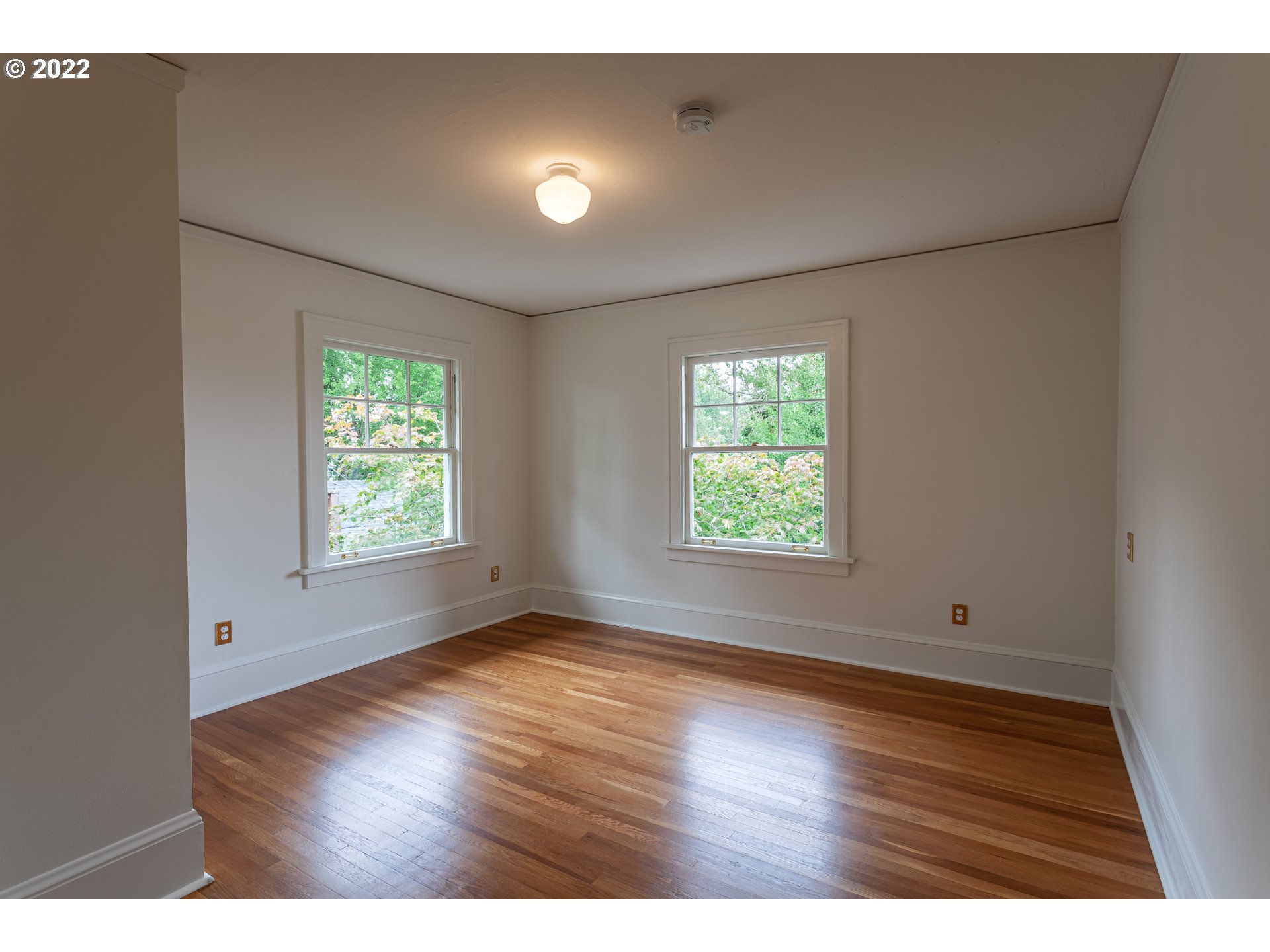 3345 Northeast Holladay Street Portland, OR 97232 - Photo 17 of 32 a view of an empty room with wooden floor and a window