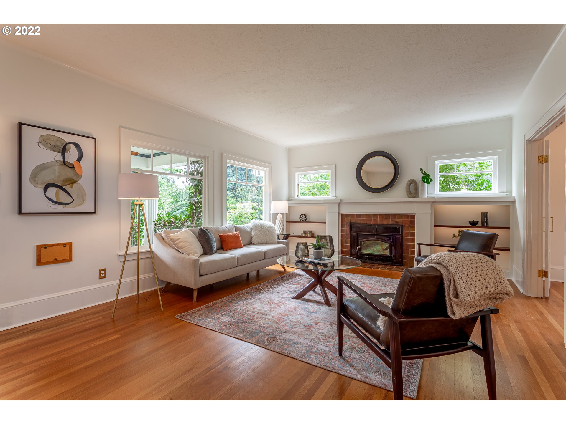 3345 Northeast Holladay Street Portland, OR 97232 - Photo 2 of 32 a living room with furniture a clock and a fireplace