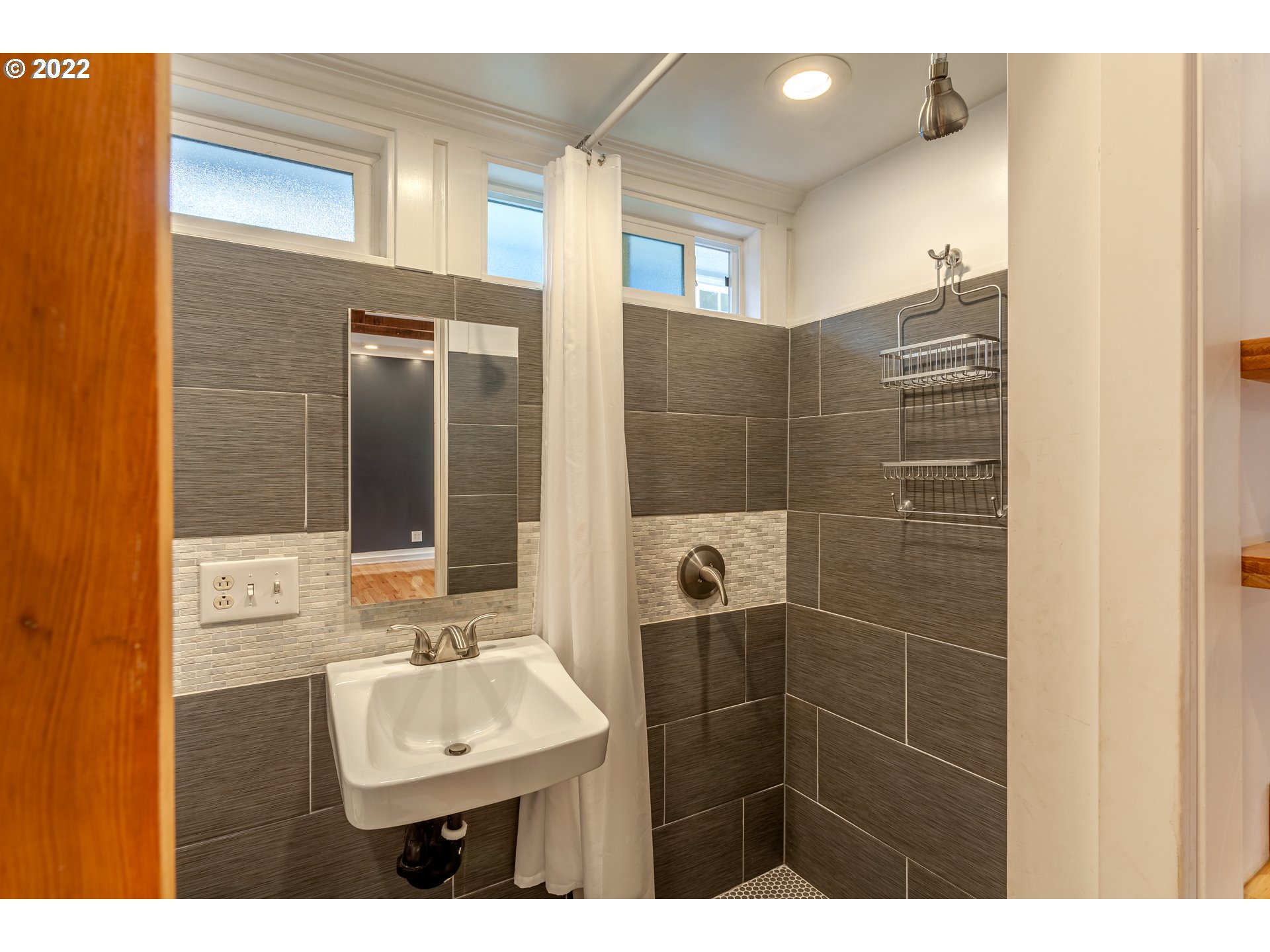 3345 Northeast Holladay Street Portland, OR 97232 - Photo 32 of 32 a bathroom with a sink mirror and shower