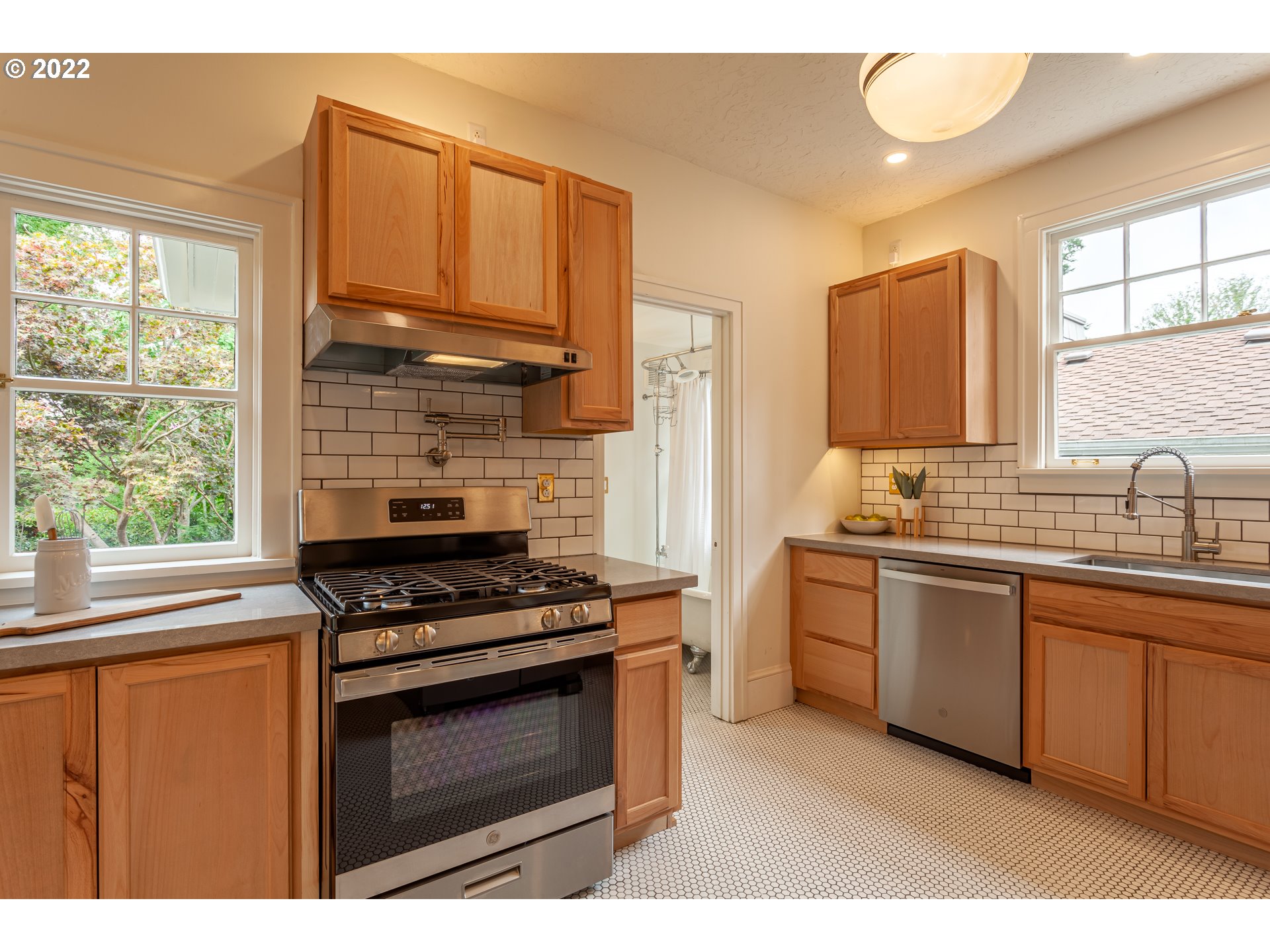 3345 Northeast Holladay Street Portland, OR 97232 - Photo 8 of 32 a kitchen with stainless steel appliances a stove sink and cabinets