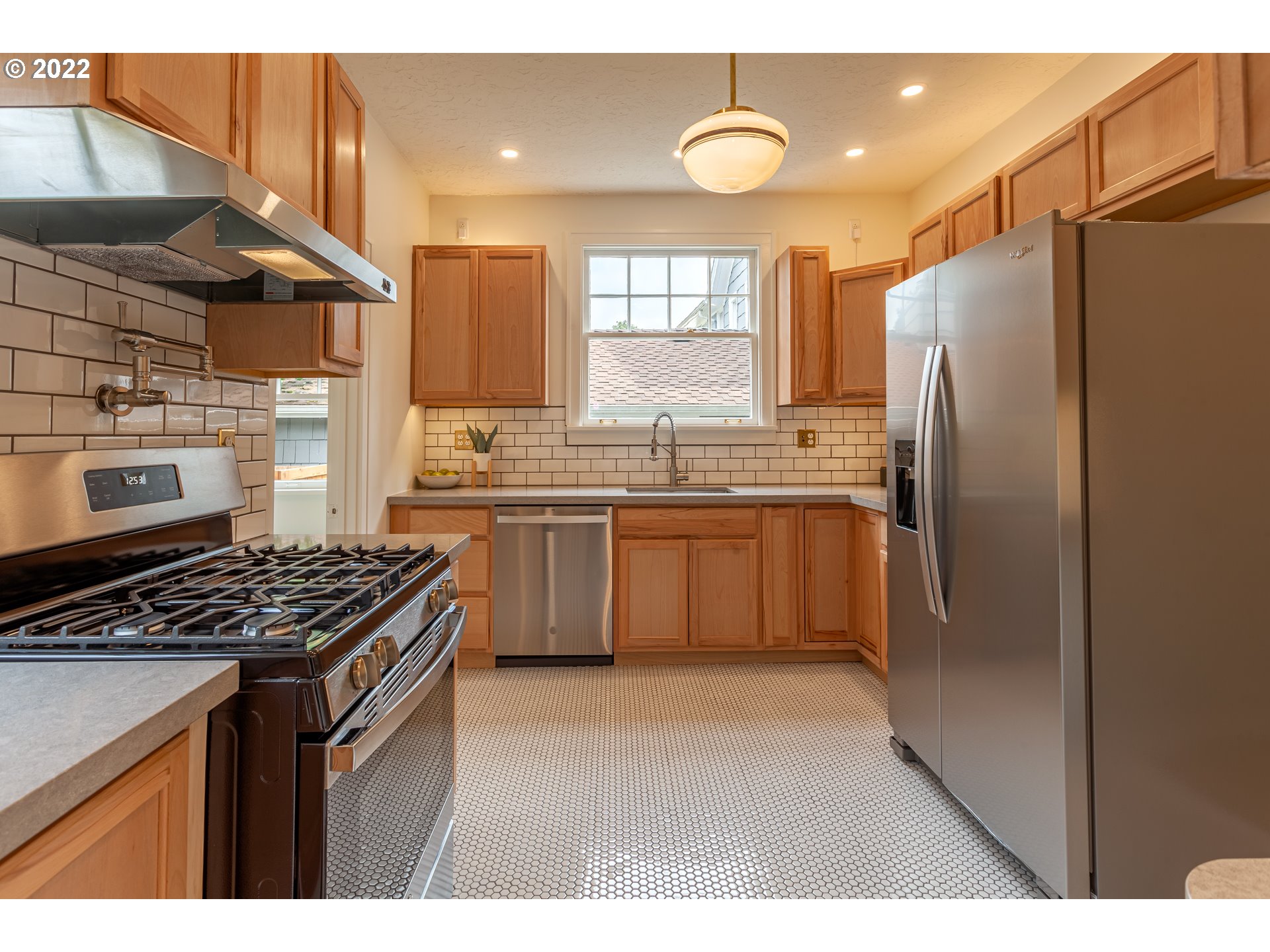 3345 Northeast Holladay Street Portland, OR 97232 - Photo 9 of 32 a kitchen with stainless steel appliances a sink stove and refrigerator