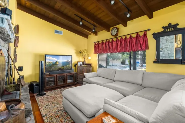 a living room with furniture a flat screen tv and a large window