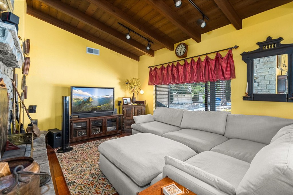 2421 Cliff Road Upland, CA 91784 - Photo 12 of 45 a living room with furniture a flat screen tv and a large window