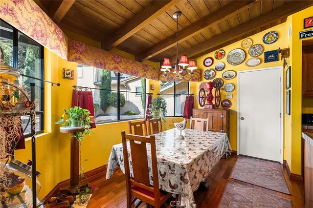 a living room with stainless steel appliances kitchen island granite countertop a table and chairs in it