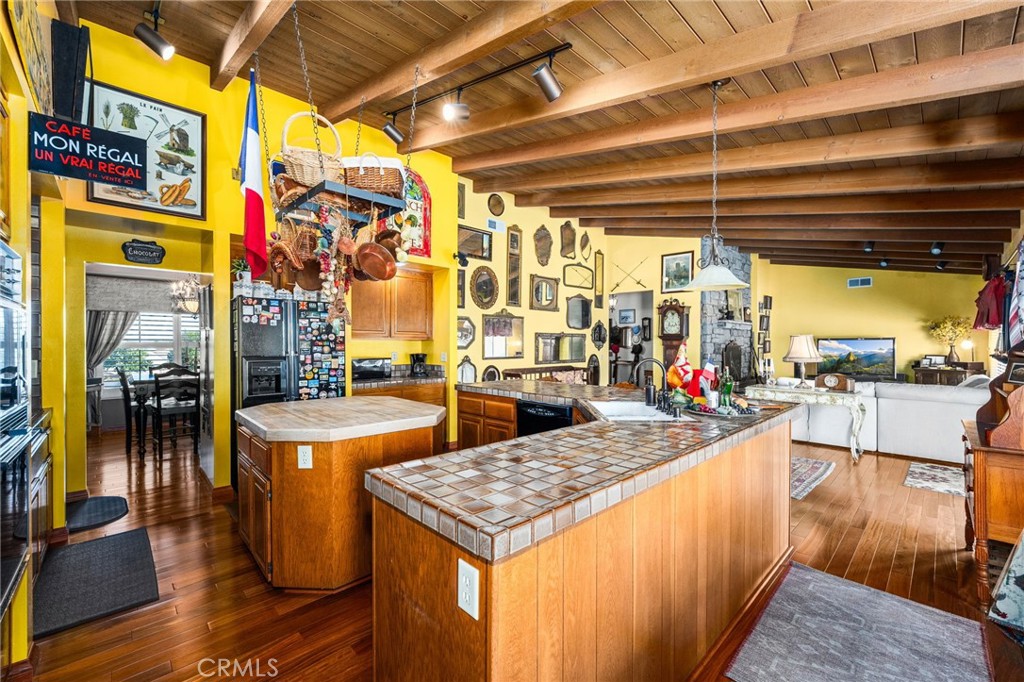 2421 Cliff Road Upland, CA 91784 - Photo 16 of 45 a living room with stainless steel appliances kitchen island granite countertop a table and chairs in it