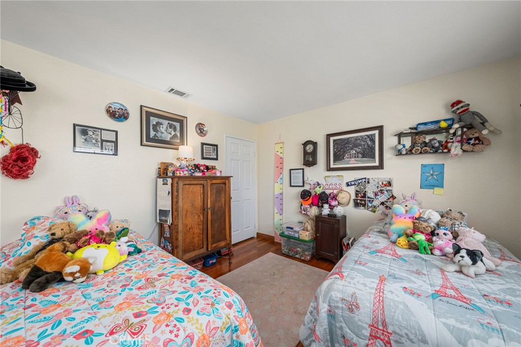 2421 Cliff Road Upland, CA 91784 - Photo 23 of 45 a bedroom with a bed and cabinets
