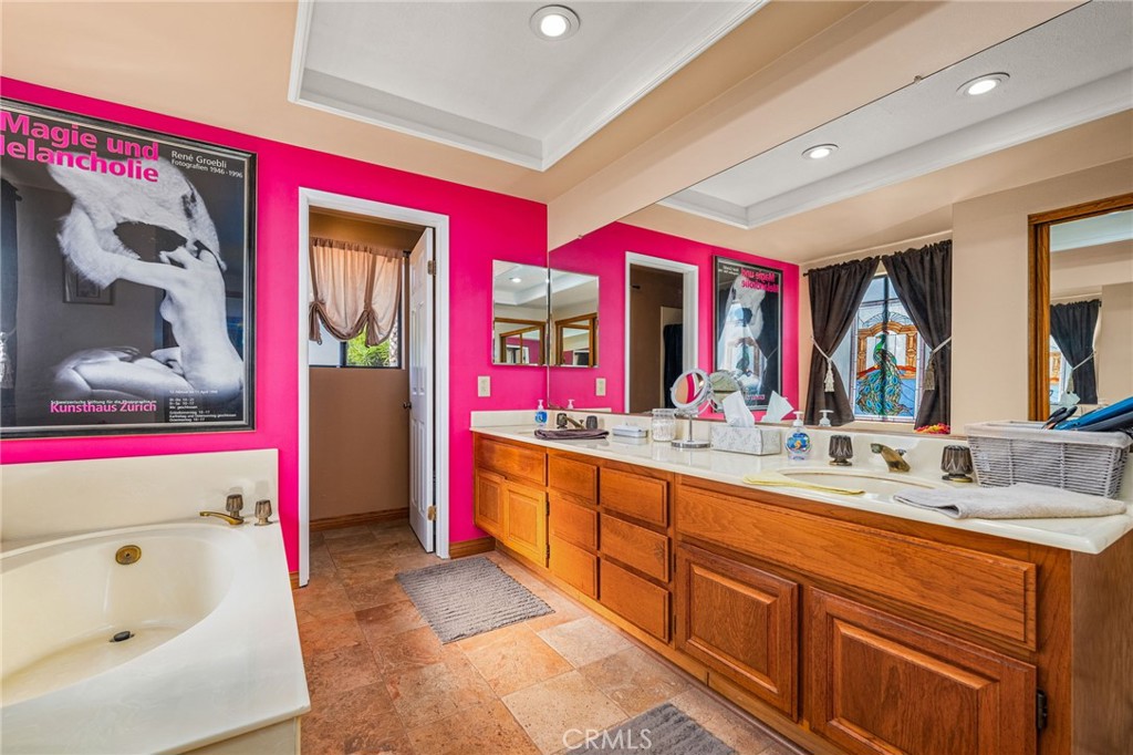 2421 Cliff Road Upland, CA 91784 - Photo 27 of 45 a spacious bathroom with a tub a sink and mirror