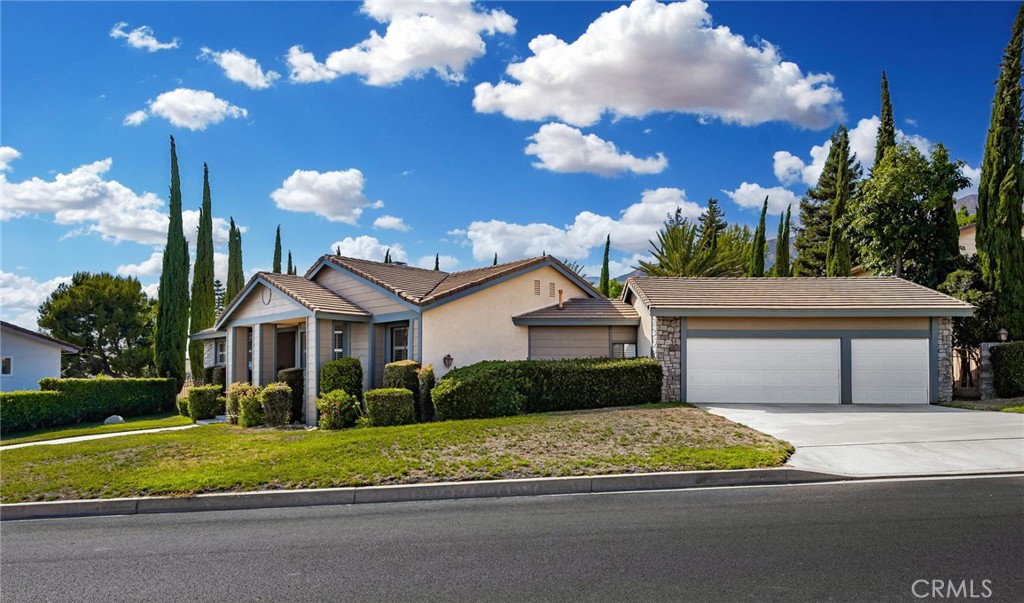 2421 Cliff Road Upland, CA 91784 - Photo 3 of 45 a front view of a house with a yard and garage