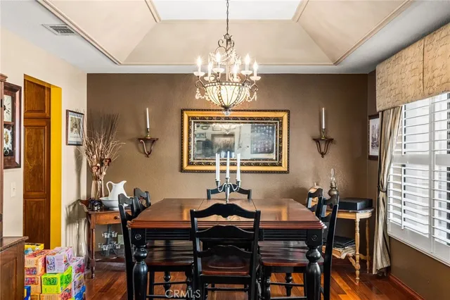 a view of a dining room with furniture and a chandelier