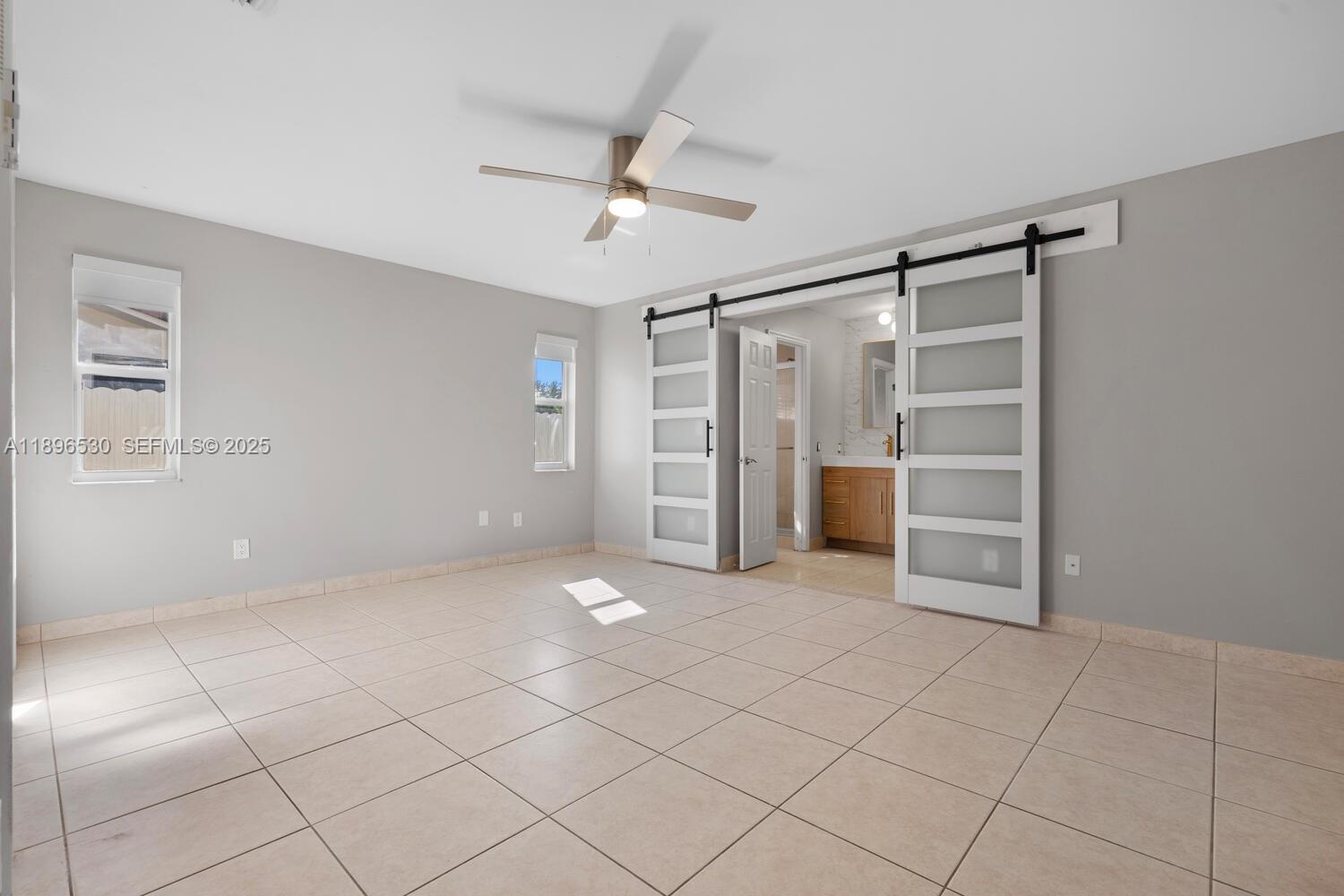 14020 Southwest 38th Street Miami, FL 33175 - Photo 11 of 21 a view of an empty room with a ceiling fan