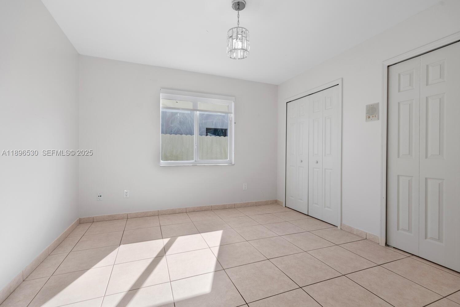 14020 Southwest 38th Street Miami, FL 33175 - Photo 17 of 21 a view of an empty room with windows