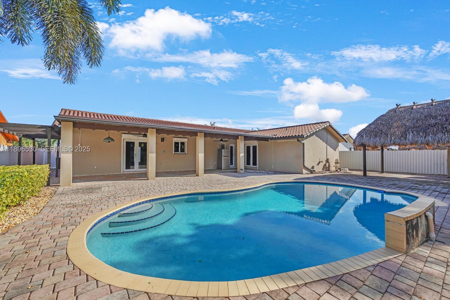 14020 Southwest 38th Street Miami, FL 33175 - Photo 20 of 21 swimming pool view with a seating space