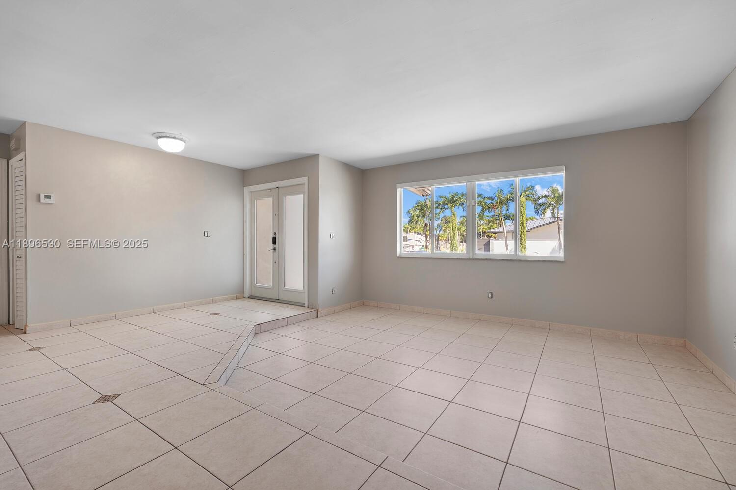 14020 Southwest 38th Street Miami, FL 33175 - Photo 3 of 21 an empty room with windows