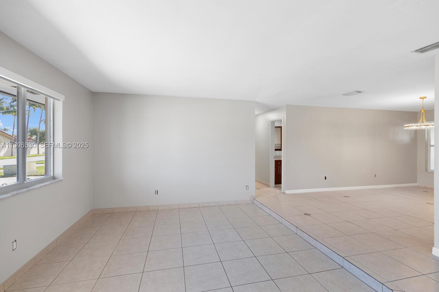 14020 Southwest 38th Street Miami, FL 33175 - Photo 4 of 21 an empty room with windows