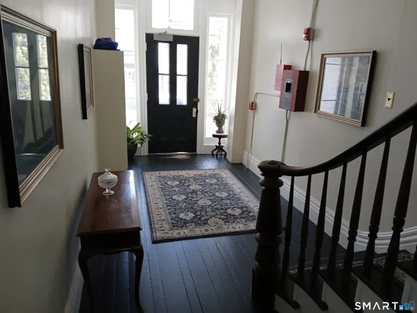 a view of entryway and hall with wooden floor