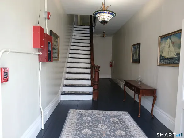 a view of entryway with stairs and wooden floor