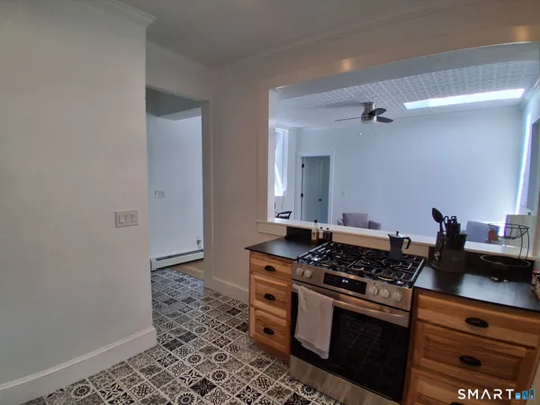 a kitchen with stainless steel appliances granite countertop a stove a sink and a refrigerator