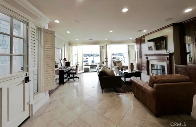 a kitchen with stainless steel appliances granite countertop a sink a stove a refrigerator cabinets and chairs