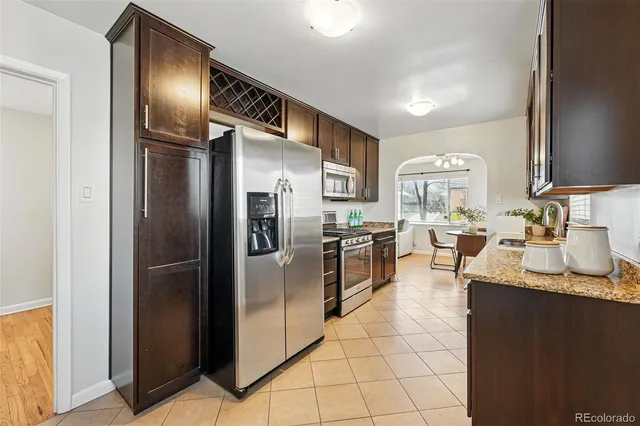 a kitchen with granite countertop stainless steel appliances and a refrigerator