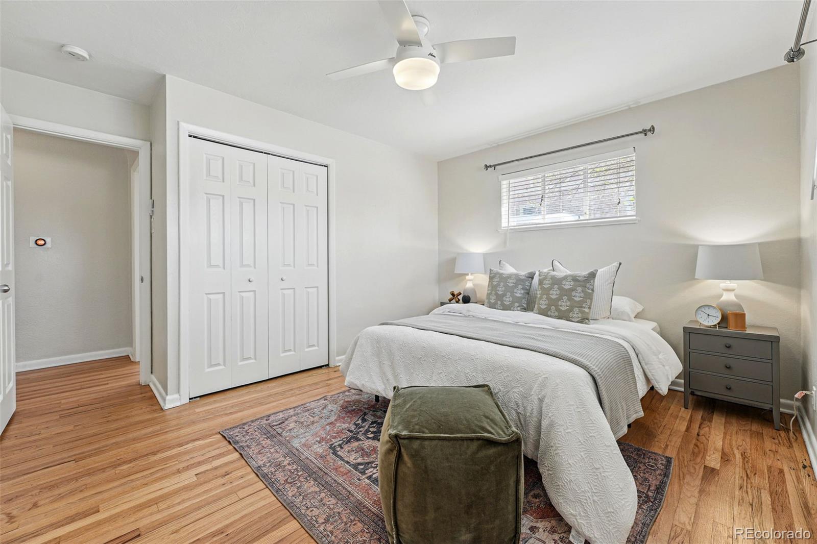 1632 Ulster Street Denver, CO 80220 - Photo 15 of 26 a bedroom with a bed and wooden floor