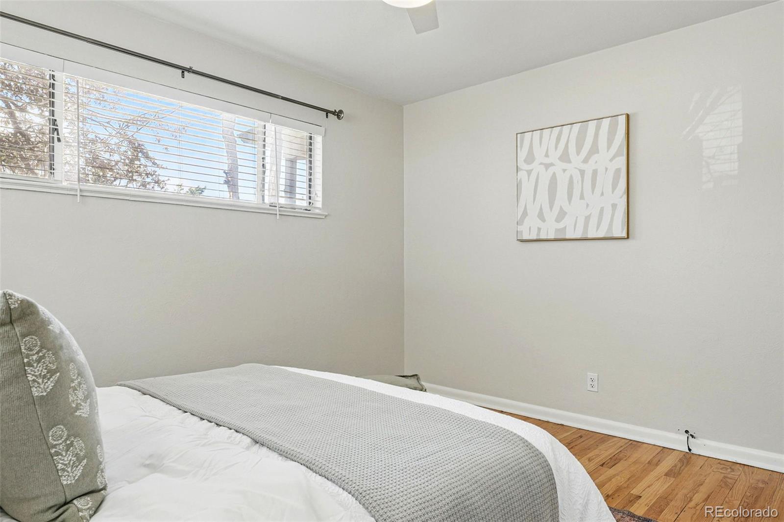 1632 Ulster Street Denver, CO 80220 - Photo 17 of 26 a bedroom with a bed and a window