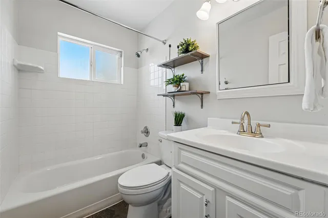 a bathroom with a sink mirror vanity and toilet