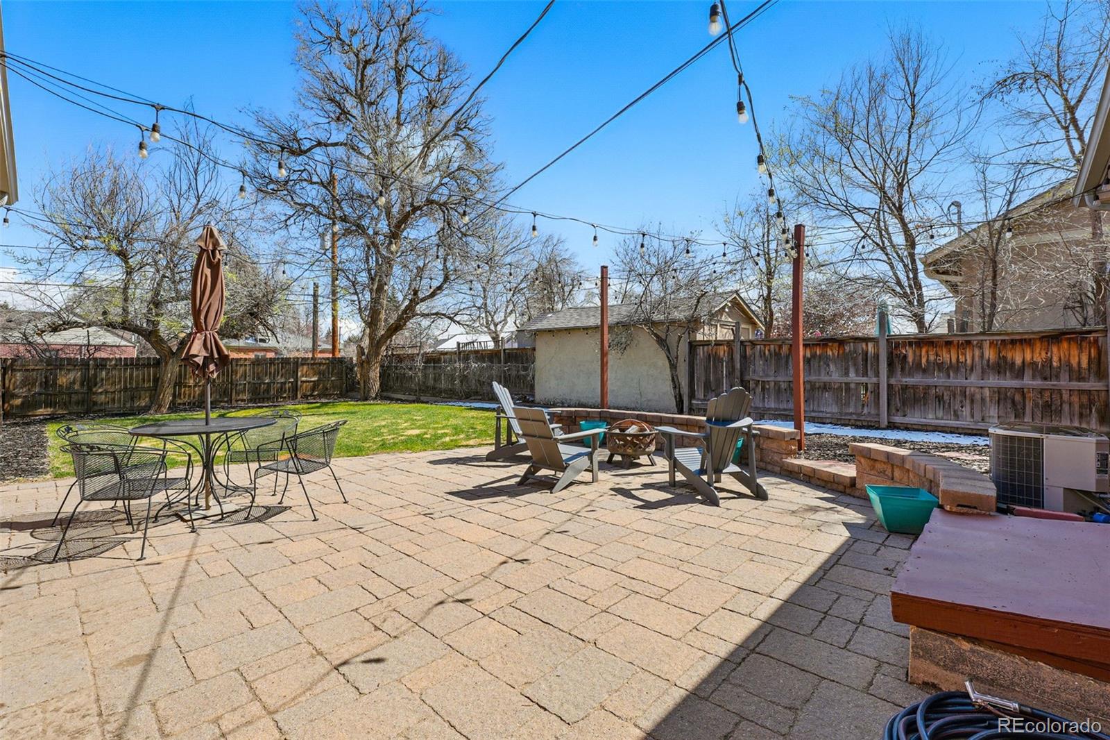 1632 Ulster Street Denver, CO 80220 - Photo 22 of 26 a view of a patio with a table and chairs