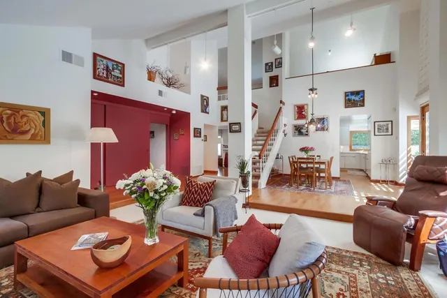 a view of a dining room with furniture and a large window