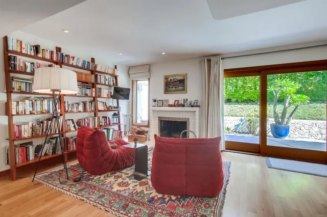 a kitchen with kitchen island a large counter top space appliances and a living room view