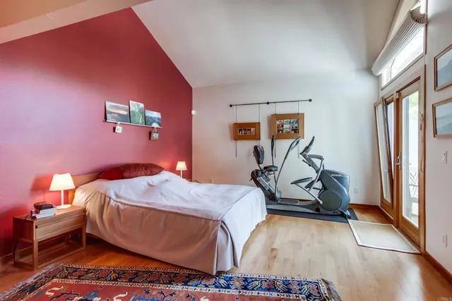 a bedroom with a bed and gym equipment