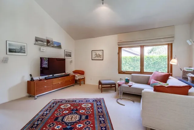a view of a workspace with lounge chair and a window
