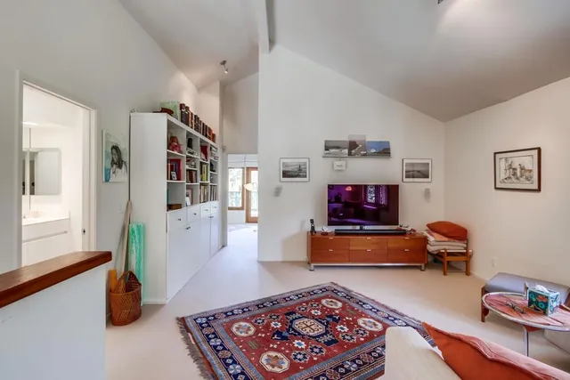 a view of a patio with table and chairs potted plants and large tree