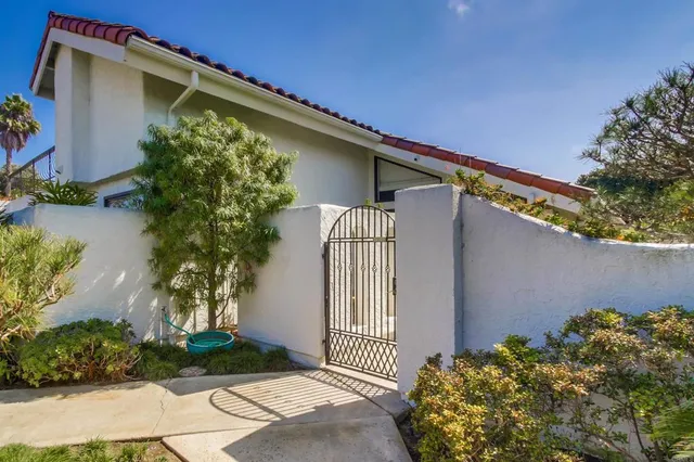 a house that has a tree in front of it